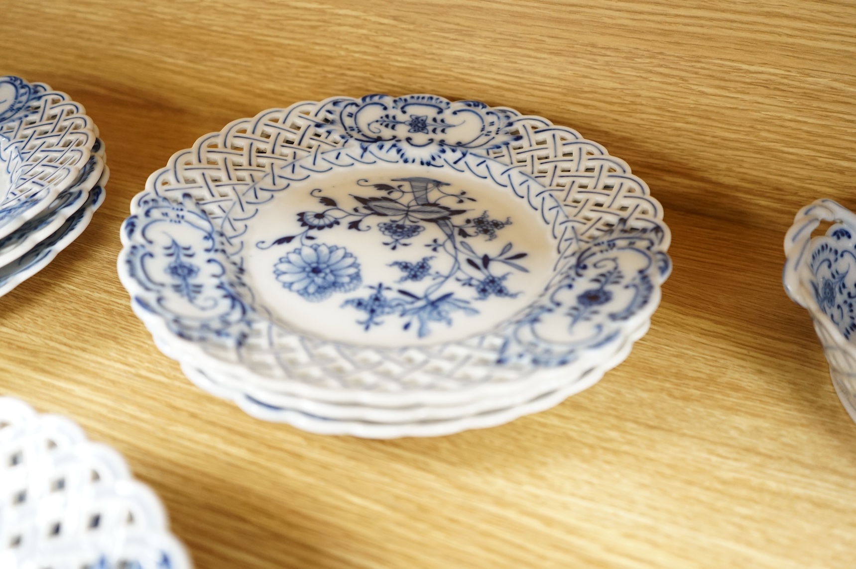A ‘Meissen’ blue onion pattern dessert service comprising nine plates and two oval twin handled dishes, 24cm wide